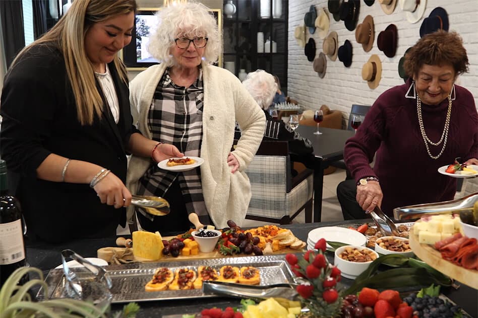 residents making plates of event buffet